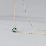 Close-up of 9ct yellow gold pendant showcasing a natural Australian teal sapphire on an ultra-fine chain, available at York Jewellers Penrith.