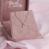 Close-up of 9ct yellow gold Sagittarius pendant showcasing 15 carcelated round brilliant cut diamonds (0.09ct total) available at York Jewellers Penrith.