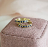 Side profile of 9ct yellow gold sapphire and diamond huggie hoop earrings showing the close-fitting silhouette.