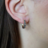 9ct yellow gold sapphire and diamond huggie hoop earrings worn on the ear showing colour and sparkle, available at York Jewellers Penrith.