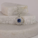 Striking 18ct white gold sapphire halo pendant available from Sydney fine jeweller York Jewellers featuring natural blue sapphire and diamond detailing.