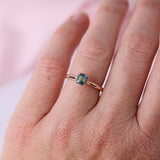 Close-up of emerald cut sapphire showing blue-green colour tones in warm rose gold engagement ring available at York Jewellers Penrith and Warriewood (Sydney).