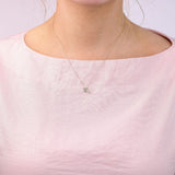 9ct yellow gold Scorpio diamond pendant worn at the collarbone showing the scorpion symbol and diamond detail.
