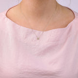 9ct yellow gold Taurus diamond pendant worn at the collarbone showing the bull symbol and diamond detail.