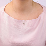 9ct yellow gold Virgo diamond pendant worn at the collarbone showing the maiden symbol and diamond detail.
