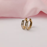 9ct yellow gold hexagonal hoop earrings showing geometric design and channel set diamond detail available at York Jewellers Penrith.