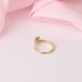 Underside angle view of yellow gold four-claw setting holding emerald cut parti sapphire engagement ring, available at York Jewellers. 